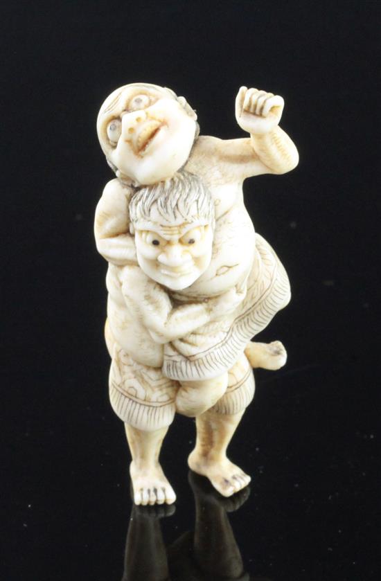 A Japanese ivory netsuke of two sumo wrestlers, 19th century, 5.8cm